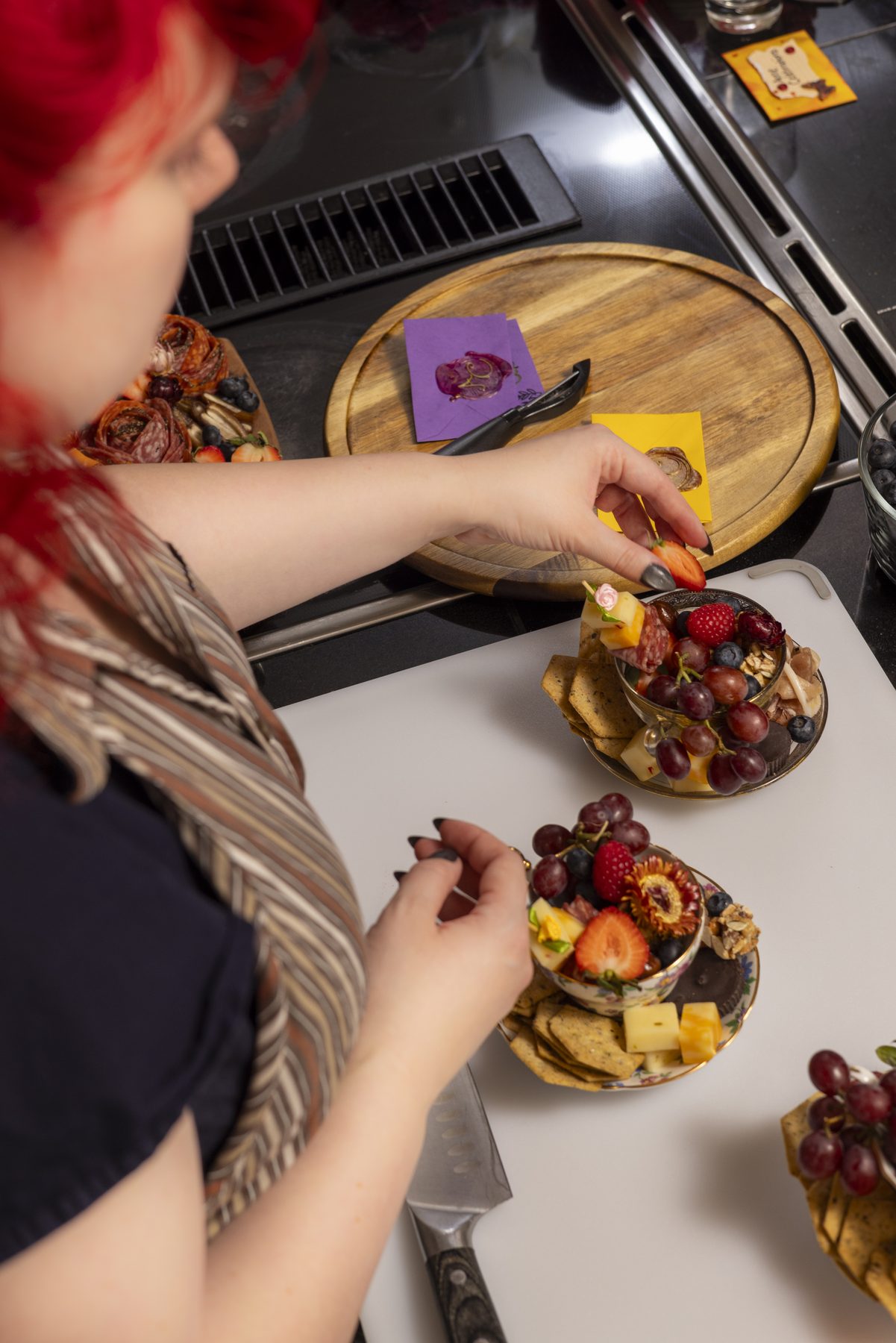 Charcuterie board with arranged cheeses, fruit, and snacks